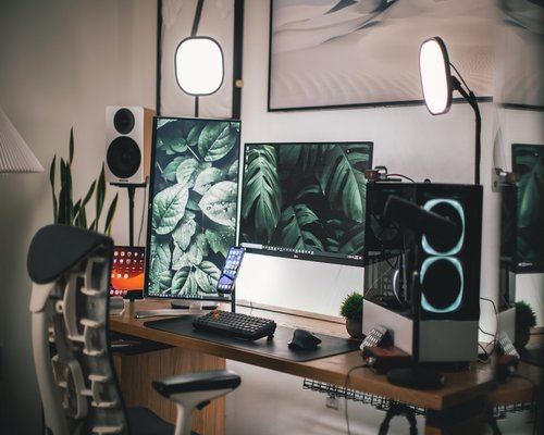 Ergonomic home office setup with proper monitor height and soft background lighting